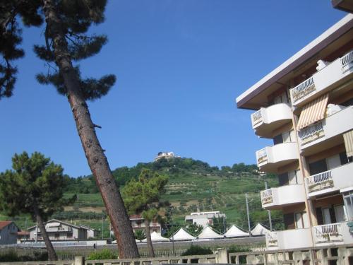 a view of a building with a hill in the background at Verde Mare in Silvi Marina