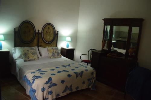 a bedroom with a bed and a mirror at B&b Lemon Garden in Sciacca