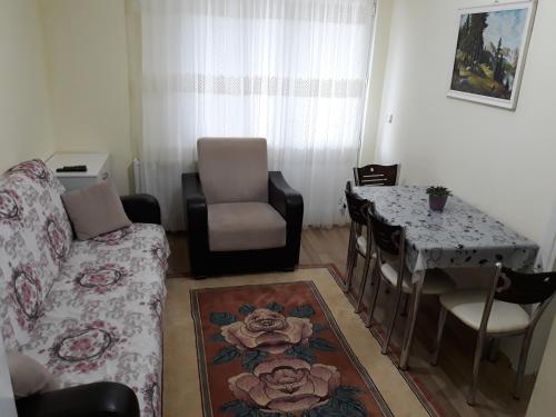 a living room with a couch and a table at Cerit Pansiyon in Gokceada Town