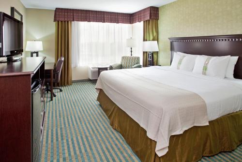 a hotel room with a large bed and a desk at Holiday Inn Columbia East, an IHG Hotel in Columbia