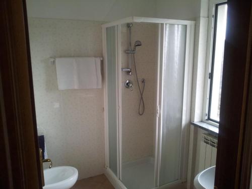 a bathroom with a shower and a toilet and a sink at Agriturismo Bell'Aria in Uscio