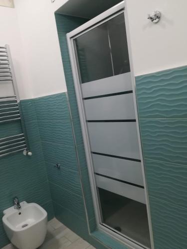 a bathroom with a shower and a toilet and a sink at Guest House Domus Cicerone in Formia