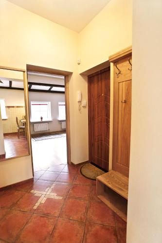 a room with a door and a tile floor at Aparthotel Stora Antis in Klaipėda