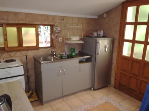 a kitchen with a sink and a refrigerator at Guest House Vila Bak in Budva