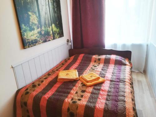 a bedroom with a bed with two bags on it at Couple getaway to a freshly renovated apartment in Pärnu