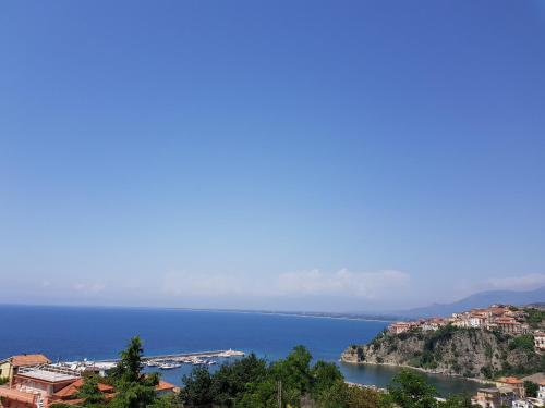 a view of a body of water with houses on a hill at Lodge Rosa in Agropoli