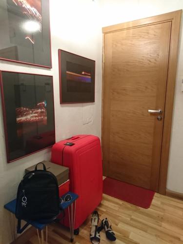 a room with a red suitcase and a door at Olga apartment in Rīga