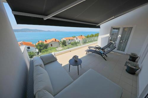 a living room with a couch and a view of the ocean at Villa Perla in Zadar