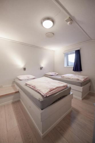two twin beds in a room with a window at Maristova apartment 110 in Filefjell