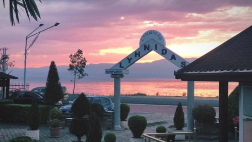 a sign for a hotel with a view of the ocean at Hotel Lyhnidas in Pogradec