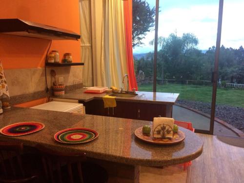 a kitchen with a table with a plate of food on it at NUESTRA CASA - OUR HOME Suite-Studio Cuenca by A2CC in Cuenca