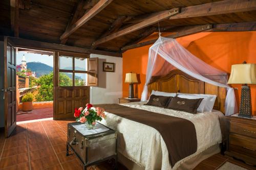 a bedroom with a large bed and a window at Santa Elena Hotel Boutique in Mascota