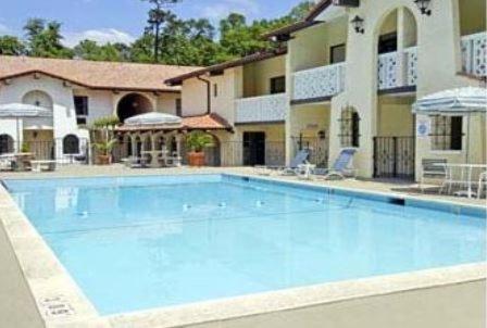 a large swimming pool in a residential area at La Casa Inn and Suites in Tallahassee