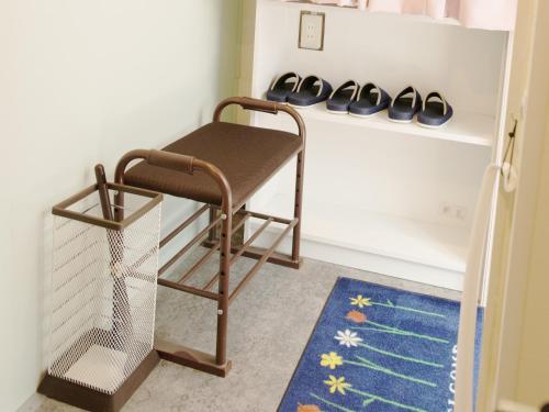 a chair in a room with a shelf with shoes at Akasakano-sato(Premium) in Tokyo