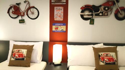 a bedroom with a bed with a motorcycle on the wall at Bayview Country Inn El Nido in El Nido