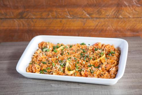 a casserole dish of food sitting on a table at Pousada Sol e Mar in Juquei