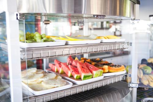 a refrigerator filled with lots of different types of food at Pousada Sol e Mar in Juquei