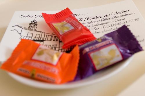 a plate with some chocolates and a piece of paper at A l'ombre du clocher in Calenzana