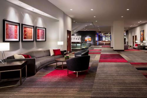 a lobby with a couch and tables in a building at Hyatt Regency Vancouver in Vancouver