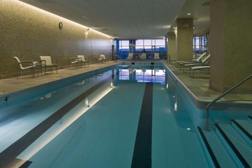 a large swimming pool with blue water in a building at Hyatt Regency Denver at Colorado Convention Center in Denver