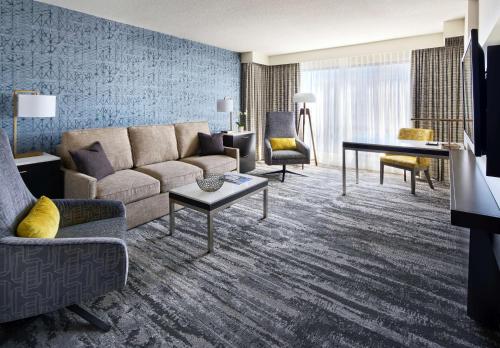 a living room filled with furniture and a couch at Hyatt Regency Vancouver in Vancouver