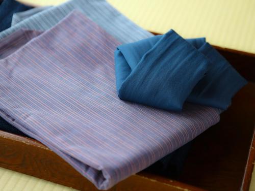
a piece of blue fabric sitting on top of a wooden table at Kamisuwa Onsen Aburaya Ryokan in Suwa
