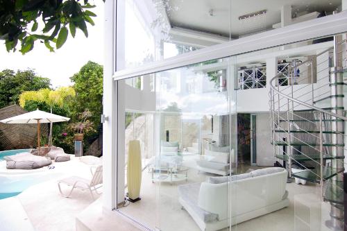 a house with glass walls and a patio at Sunshine Ocean Sea View in Chaweng