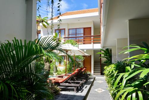 a row of benches sitting outside of a building at Asoka Hotel & Suite in Sanur