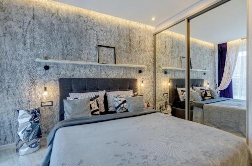 ein Schlafzimmer mit einem großen Bett in einem Zimmer in der Unterkunft Black & White Apartment near Akropolis in Vilnius