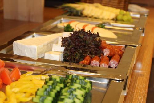 a buffet with several trays of different types of food at Hotel Lobmeyer in Roding