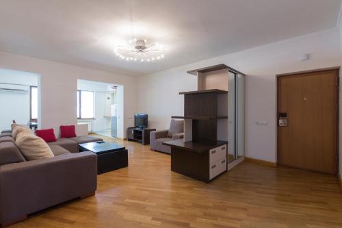 a living room with a couch and a tv at Umba Apartment N2 in Yerevan