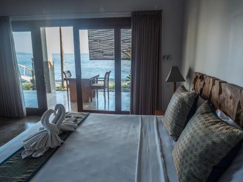 Ένα ή περισσότερα κρεβάτια σε δωμάτιο στο Amed Beach Villa