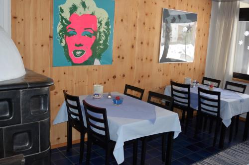a dining room with two tables and a stove at Hotel Leitgebhof in Innsbruck