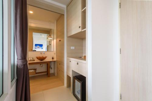 a small bathroom with a sink and a mirror at Costa Village Bangsaray in Bang Sare