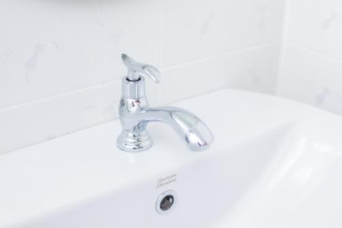 a bathroom sink with a chrome faucet at Samrong Garden in Udon Thani