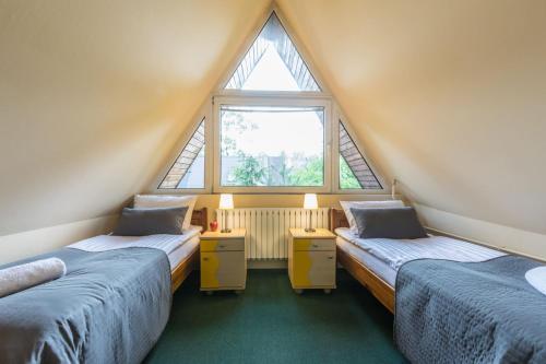 Ένα ή περισσότερα κρεβάτια σε δωμάτιο στο Liberta INN - Pokoje Gościnne