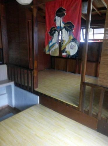 a room with wooden floors and a flag on the wall at Villa Triniti Blok i-35 in Bandung