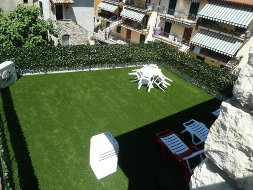an aerial view of a lawn with a table and chairs at Albergo Casa Este in Brenzone sul Garda