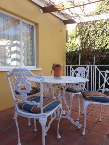 a white table and chairs on a patio at The Lighthouse Guesthouse in Colesberg