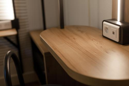 a wooden table with a microwave on top of it at B&B HOTEL Bordeaux Centre Gare Saint-Jean in Bordeaux