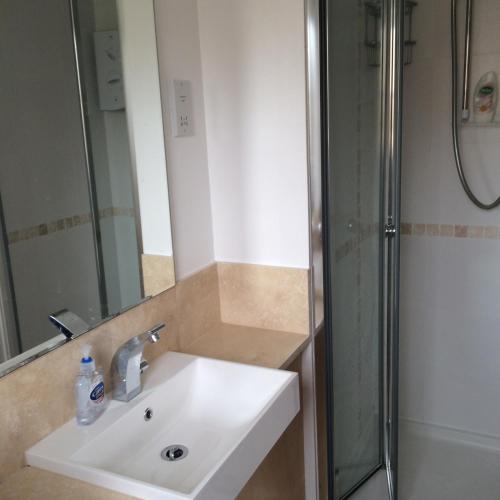 a bathroom with a sink and a shower at Beautiful Kingston apartment in Kingston upon Thames