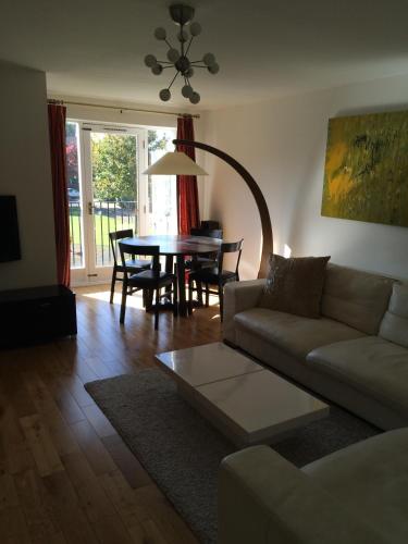 a living room with a couch and a table at Beautiful Kingston apartment in Kingston upon Thames