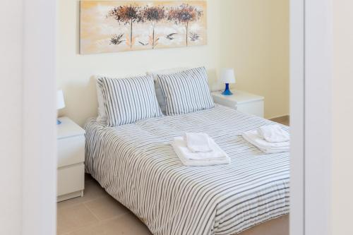 a bedroom with a bed with two towels on it at Pedros Apartment by Seewest in Lagos