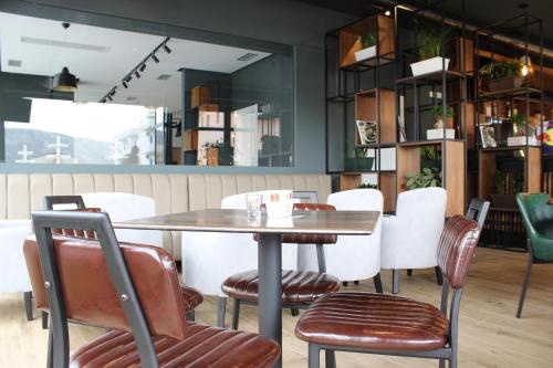 a dining room with a table and chairs at Domus Hotel & Apartments in Shëngjin