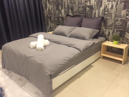 a bed with a stuffed animal on top of it at SHAHALAM ALLBESS@TREFOIL in Setia Alam