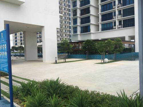 an empty parking lot in front of a building at SHAHALAM ALLBESS@TREFOIL in Setia Alam