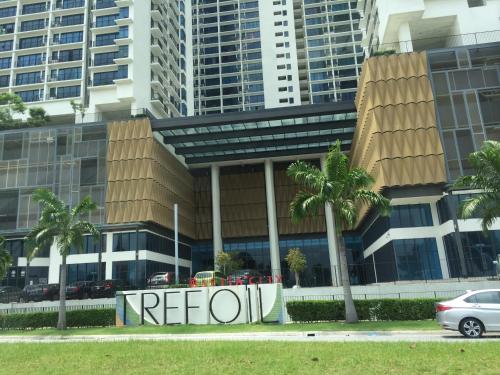 a referon sign in front of a building with palm trees at SHAHALAM ALLBESS@TREFOIL in Setia Alam