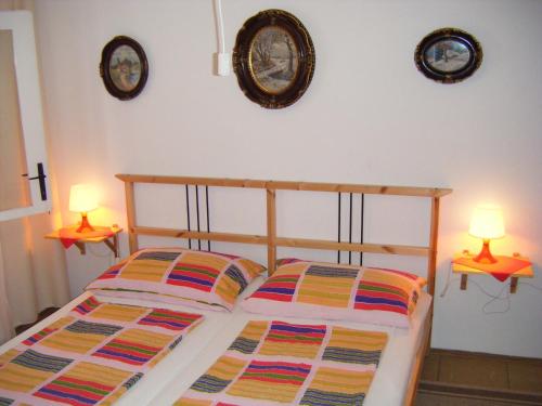 a bedroom with a bed and two clocks on the wall at Apartments Adria Blue in Jelsa