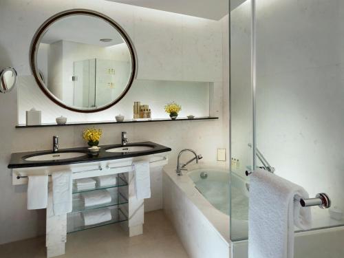 a bathroom with a sink and a tub and a mirror at Pudong Shangri-La Shanghai - With a sweeping view of the Pearl Tower and the historic Bund skyline in Shanghai