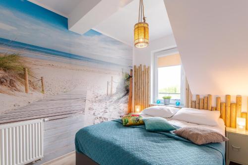 a bedroom with a beach mural on the wall at Feniks Apartamenty 8 by Jantar Apartamenty Kołobrzeg in Kołobrzeg